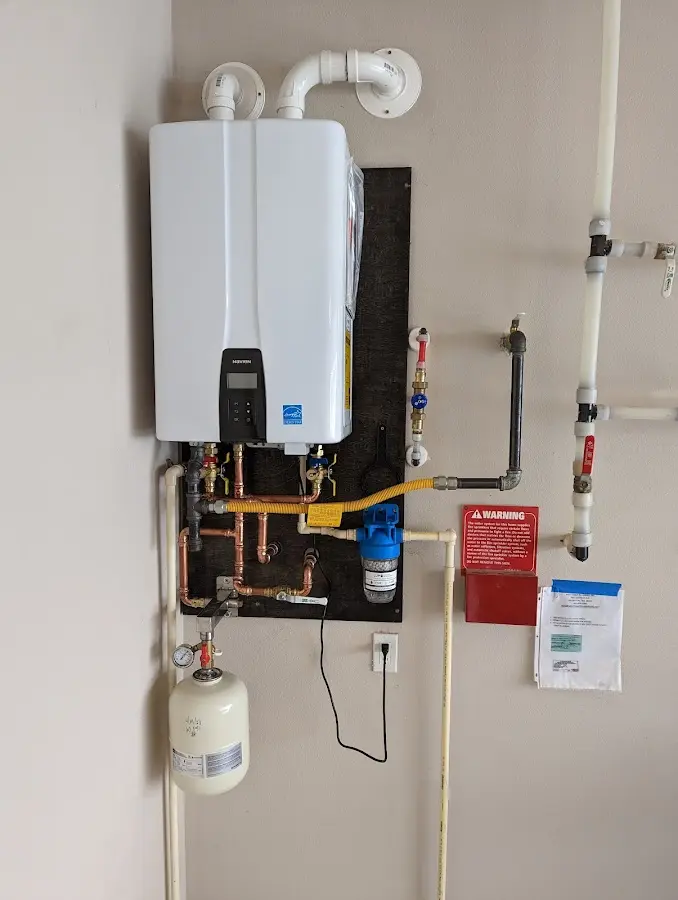 Professional plumber installing copper piping in a Gunnison home